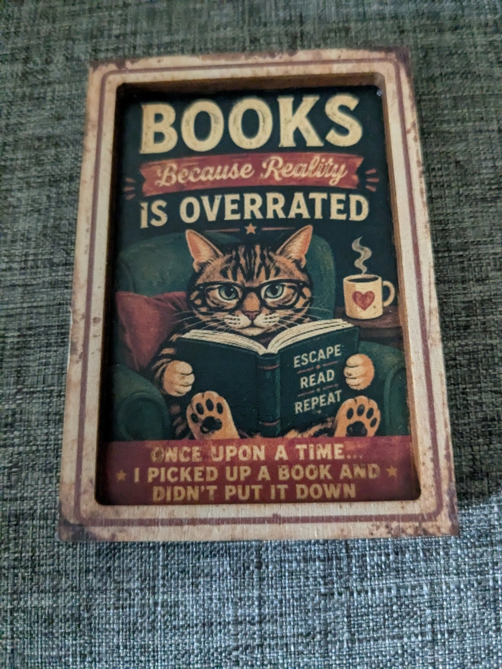 Charming brown cat magnet art featuring a cozy reading scene.